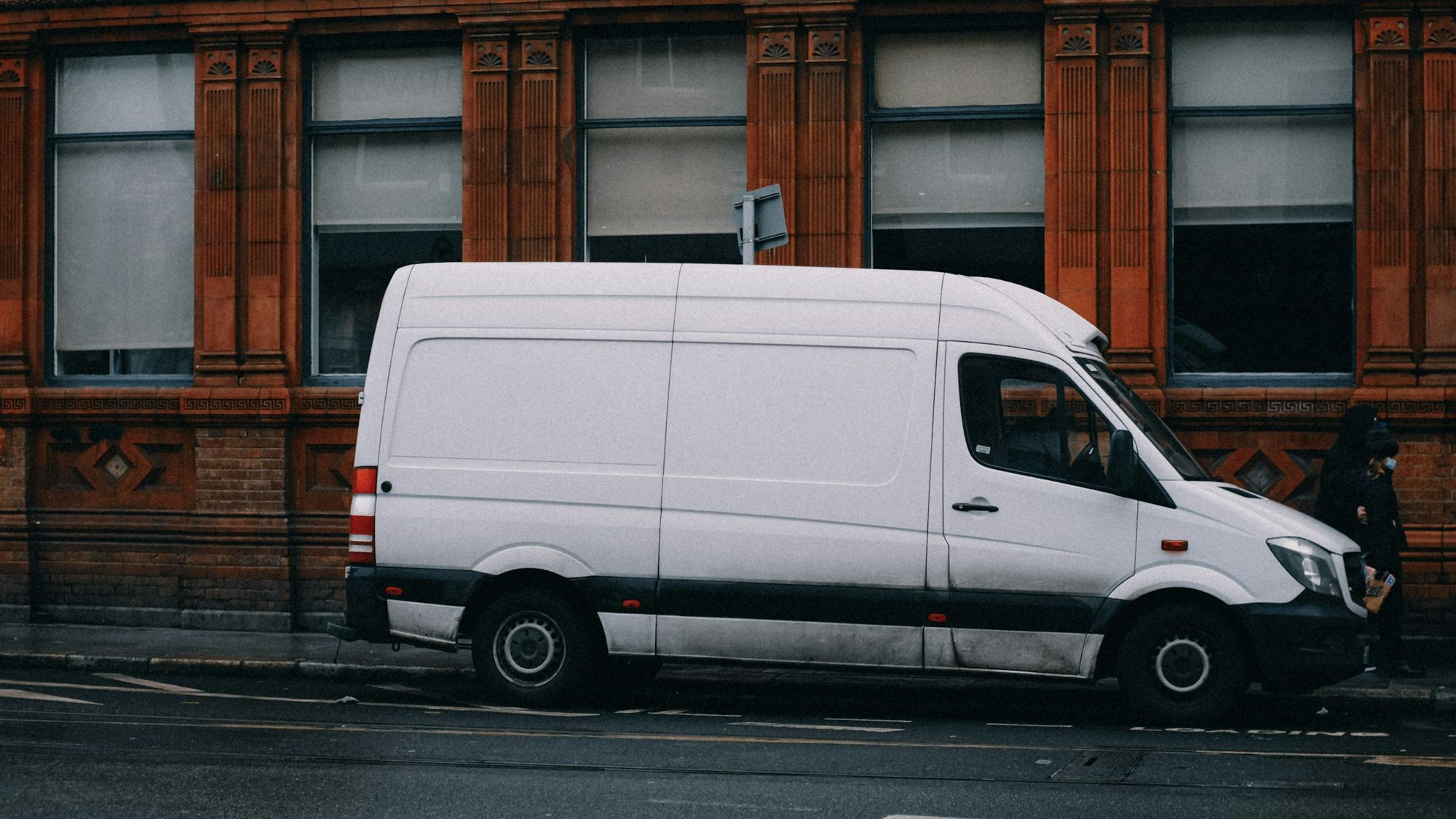 A plain white van parked at the side of a street